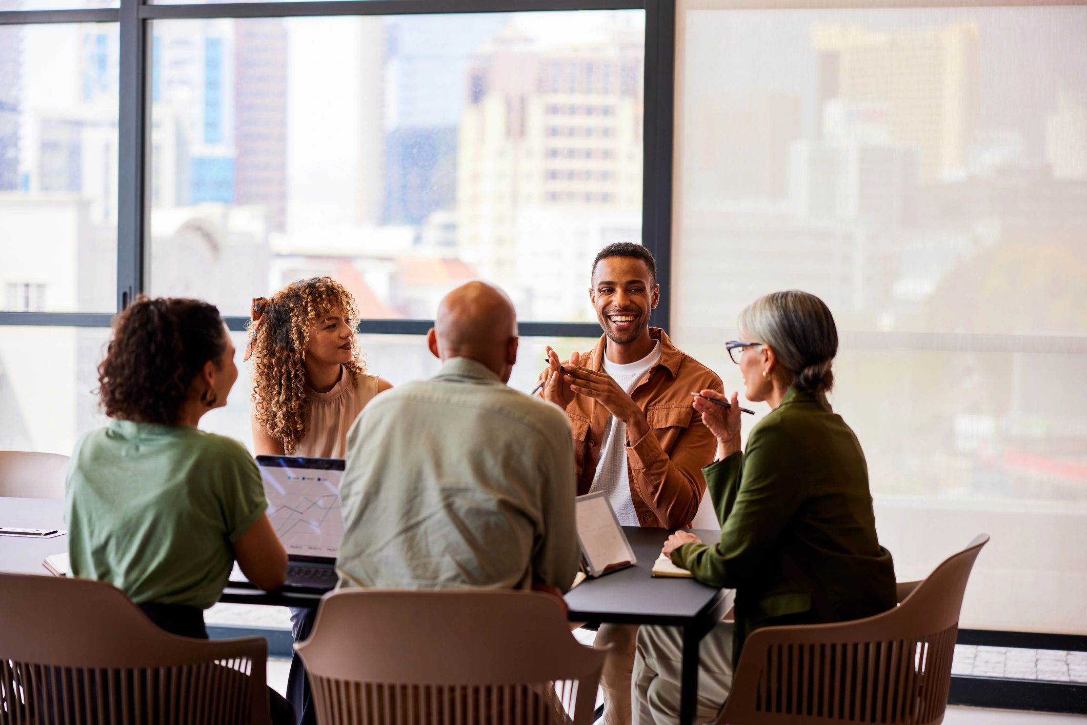 Colleagues collaborating around a table in a modern office